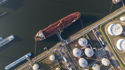 Top down view on petroleum ship loading and unloading terminal. Storage silos for gas, liquids....