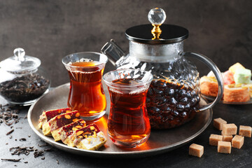 Tasty Turkish tea and delight on black table