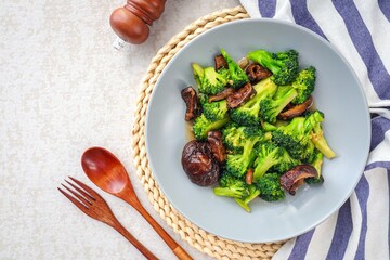 Broccoli stir fried with Shrimps Shiitake in grey ceramic plate
