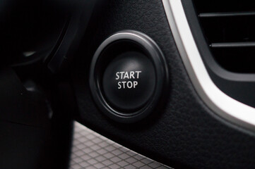 The "start-stop" button on the dashboard of a modern car