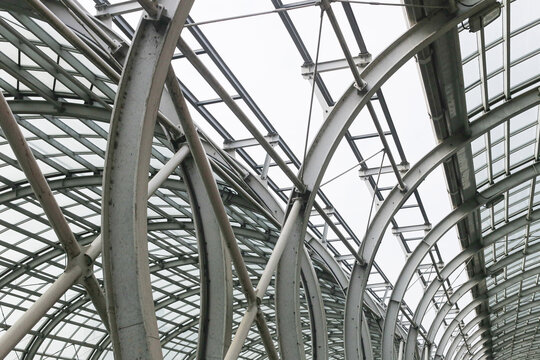 Modern steel roof structure. Glass and metal architecture. Abstract building pattern. Industrial urban design. Engineering lines. Contemporary construction. Architectural geometry. Iron frame detail