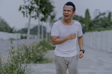 Asian man jogging in the park. Fitness Man Running, Training Run Workout.