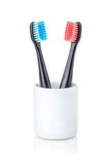 Two toothbrushes in a cup isolated on white background