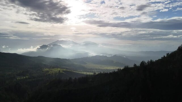 Aerial 360 panoramic view of lush mountains at sunset, Ijen higlands, East Java, Indonesia.