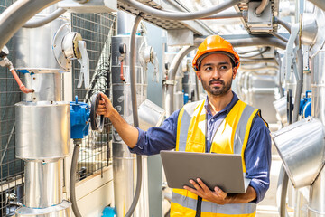 Asian male technical foreman inspects maintenance of turn off the water pipe and looking data in...