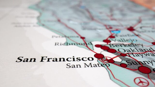 Close-up of Bay Area map showing San Jose to San Francisco commuter route, with Oakland minor cities out of focus, macro tracking left