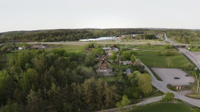 Wide aerial Drone shot flying in towards Sunvära kvarn Museum and windmill in Sweden.