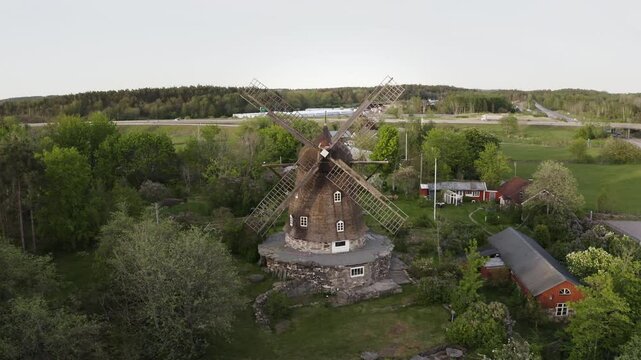 Wide aerial Drone shot moving towards Sunvära kvarn Museum and windmill in Sweden.