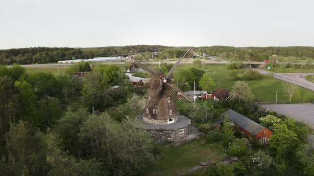 Wide aerial Drone shot moving around Sunvära kvarn Museum and windmill in Sweden.