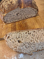 freshly cut artisanal sourdough bread showing crumb and texture on a rustic wooden surface