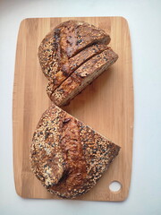 freshly cut artisanal sourdough bread showing crumb and texture on a rustic wooden surface on white table