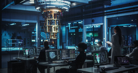 Female Computer Engineer Walking Up to Examine a Quantum Computer in a High Tech Scientific...