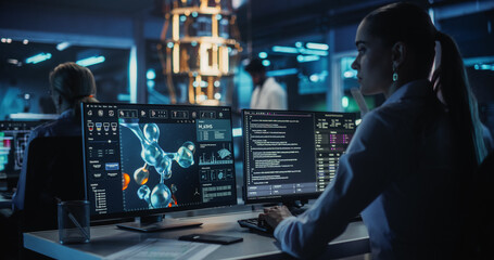 Young Female Biologist Analyzes Protein Structures on Molecular Modelling Software on a Computer....