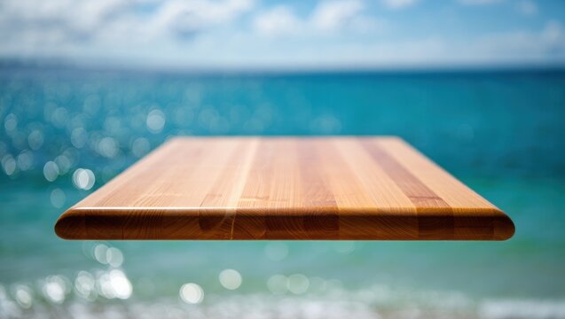 Elegant wooden tray floating above ocean waves with clear blue sky in background