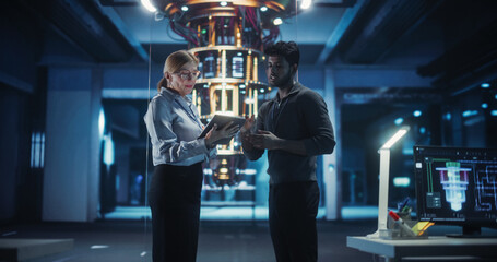 Engineers Standing in a Tech Facility and Examining a Quantum Computer Processor, Analyzing...