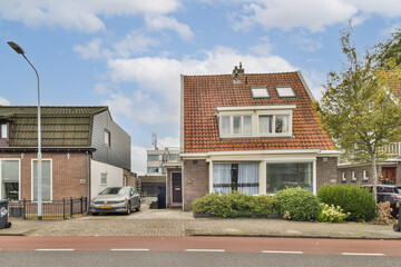 A picturesque view of two distinct houses showcasing classic Dutch architecture against a blue sky with fluffy clouds. Ideal for design and travel themes. © Casa imágenes