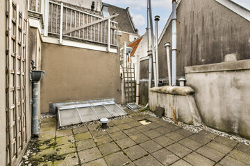 This image captures a rooftop area in an urban setting, showcasing utility pipes, flat surfaces,...