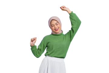 Beautiful young Asian woman in a green sweater raises arms and dances to favorite music, forgot about all problems isolated on transparent background