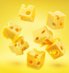 Emmental or Maasdam cheese cubes  flying in air isolated on yellow background.
