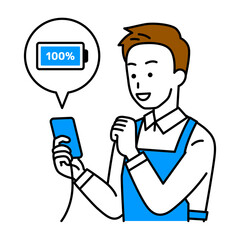 スマートフォンを充電するエプロン姿の男性