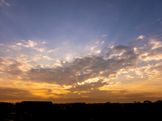 Sunrise, golden sunrise over a rural landscape in Brazil with trees in silhouettes and a bright sky on an autumn morning, natural light, selective focus.