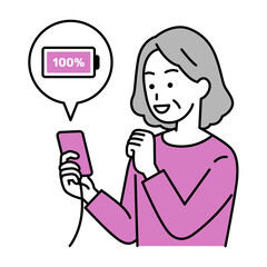 スマートフォンを充電する年配の女性