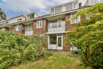 A picturesque view of a residential house nestled amidst vibrant greenery, showcasing harmonious architecture and landscaping.