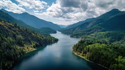 Fototapeta premium Amazing lake view, surrounded by green hills and forests, blue sky and white clouds, perfect for tourist posters and outdoor activities such as hiking, fishing, camping.