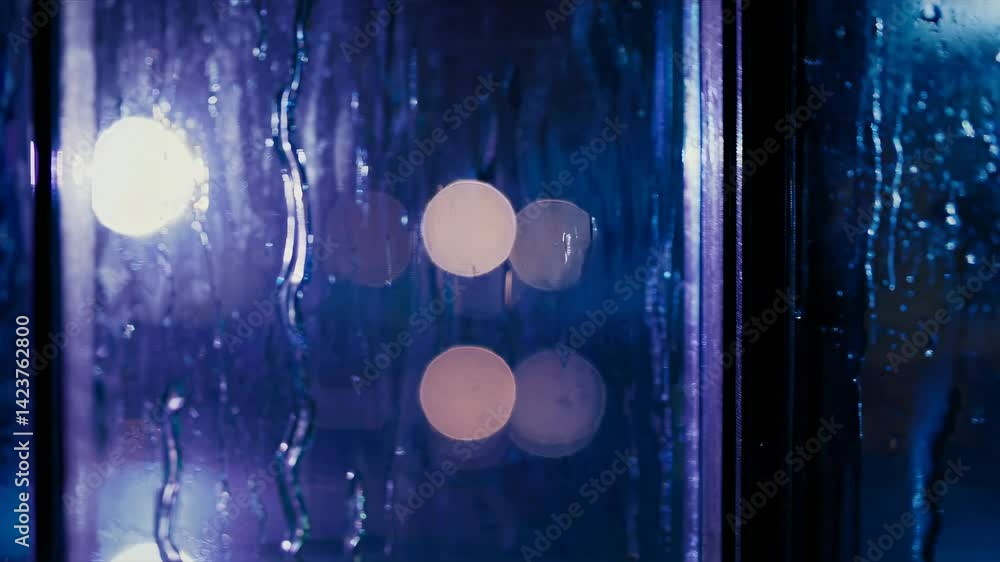 Poster moody video scene capturing raindrops on a window at night, with a close-up angle, creating a serene