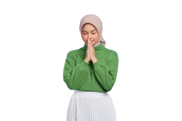 Beautiful young Asian woman in green sweater making a praying gesture with closed eyes isolated on transparent background