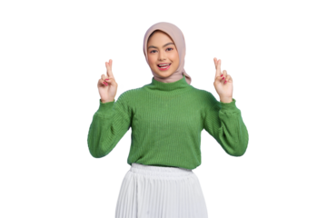 Beautiful young Asian woman in green sweater hopeful and optimistic, cross fingers for good luck, making a wish and smiling isolated on transparent background