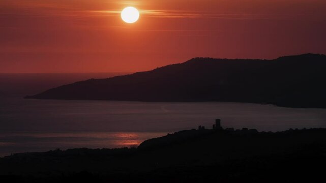 Scenic sunset over the ancient tower of the acropolis of Velia (Elea) in Ascea