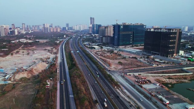 ORR with Service Road, cycle track and commercial buildings at day time, semi circle, drone shot, 4k.