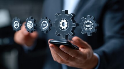 Businessman holding a smartphone and touching a gears icon with a digital hologram of icons on a virtual screen. This represents a technology business concept for information system or marketing plan