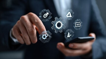 Businessman holding a smartphone and touching a gears icon with a digital hologram of icons on a virtual screen. This represents a technology business concept for information system or marketing plan