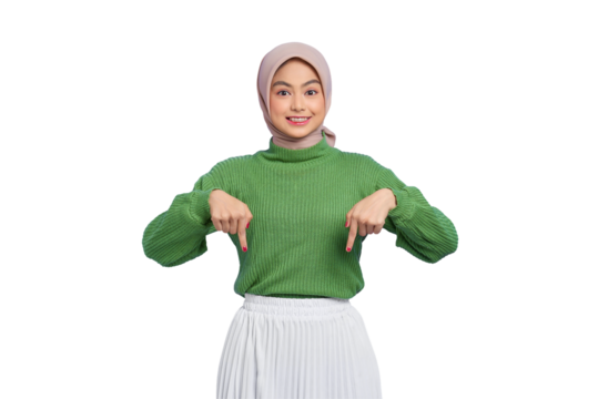 Beautiful young Asian woman in green sweater smiling pointing fingers down, inviting customers to special event isolated on transparent background