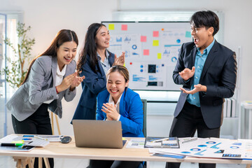 A group of people are celebrating a work accomplishment