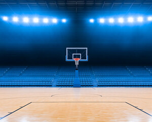 Empty basketball arena with blue seating and bright lights