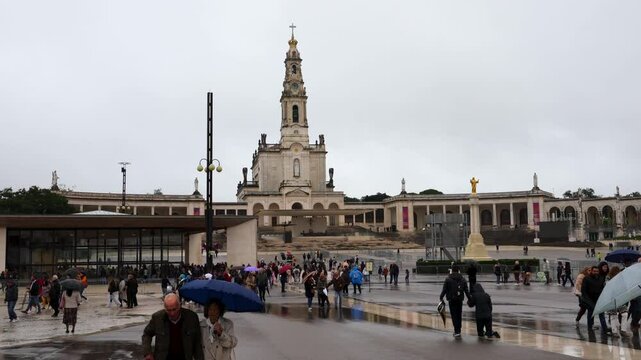 Sanctuary of Fatima, Portugal - October 31, 2024: Devotees walk the Penitential Path on knees for vows made to Our Lady after the fulfillment of requests. Fatima is a major Marian Shrine for Catholics