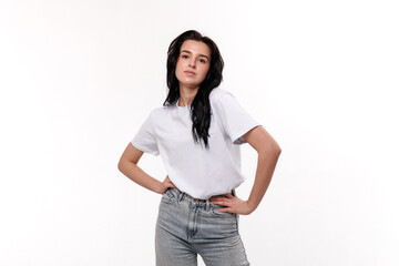 Young woman in casual outfit posing confidently against a white background in a studio setting