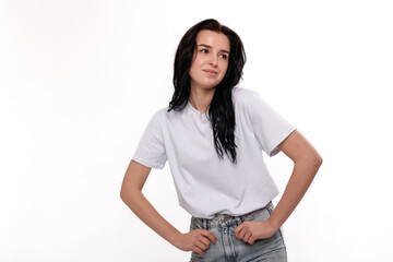 Fototapeta premium Young woman wearing casual clothes posing confidently in a studio setting with a neutral background
