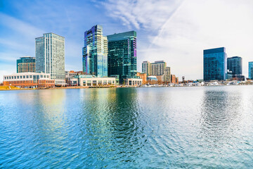 Fototapeta premium Baltimore's inner harbor with the Skyscrapers of business centers reflecting in the water.