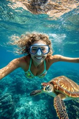 Fototapeta premium Bright commercial style image. Many tropical fish swim next to her. A stunning and sexy happy black young woman with medium hair in a swimming mask and fins snorkeling among the corals.
