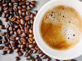 Coffee crema espresso in paper Coffee cup and bean, close-up, Top view of Espresso in  Takeaway paper coffee cup