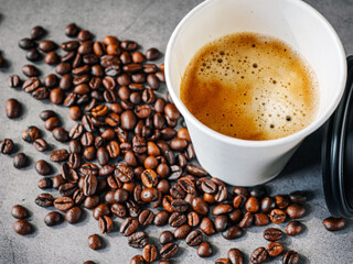 Coffee crema espresso in paper Coffee cup and bean on gray background, Top view of Espresso in  Takeaway paper coffee cup.