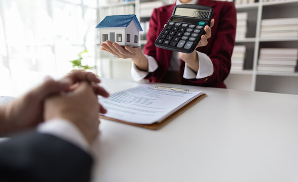 Businesswoman, real estate agents discuss offer house sale prices, fee, mortgage, interest, rent, cash flow, loan. House and land trading ideas.