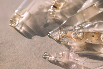 Close-up of glass pipettes with moisturizing serum with colloidal gold. Droppers with toning...