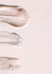 Different texture of gel and cream on a light background. Transparent serum with bubbles and colloidal gold. The consistency of glycerin gel. Various cosmetic cream smears.