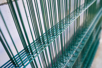 Welded mesh for fence in green color, several sections of transparent fence