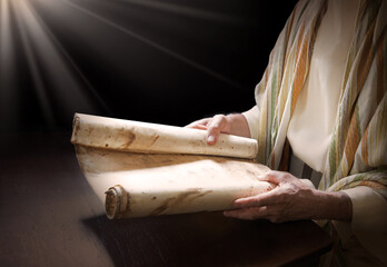 Man's hans holding a scroll